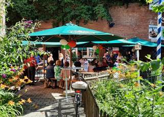 A group of people sitting under umbrellas

AI-generated content may be incorrect.